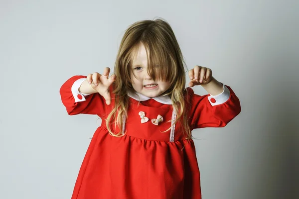 Little girl in red dress frighten photographer — Stock Photo, Image