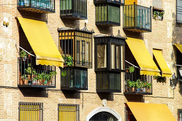 Yellow awnings on house wall — Stock Photo, Image
