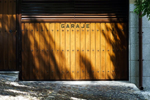 Garage gates with shadows of trees