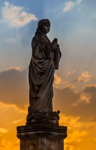 Beautiful sculpture on sunset background — Stock Photo, Image