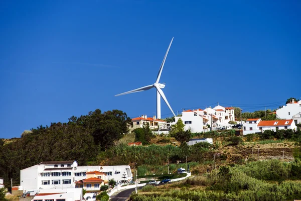 Wind energy turbine power station over the village — Stock Photo, Image