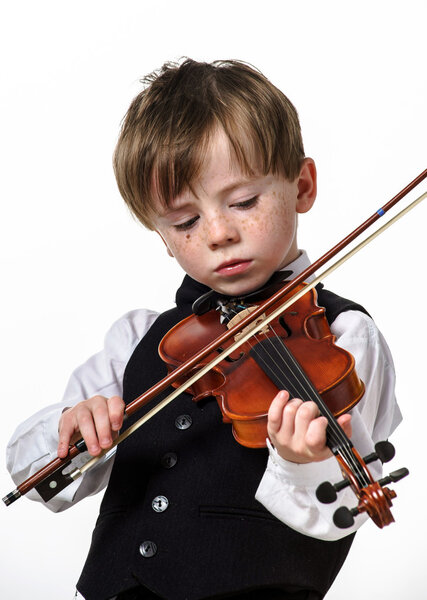 Freckled red-hair boy playing violin.