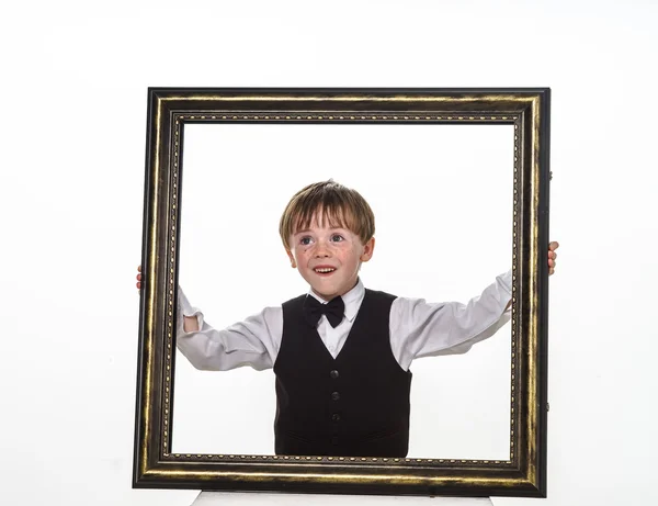 Niño pecoso de pelo rojo con marco de cuadro grande . —  Fotos de Stock