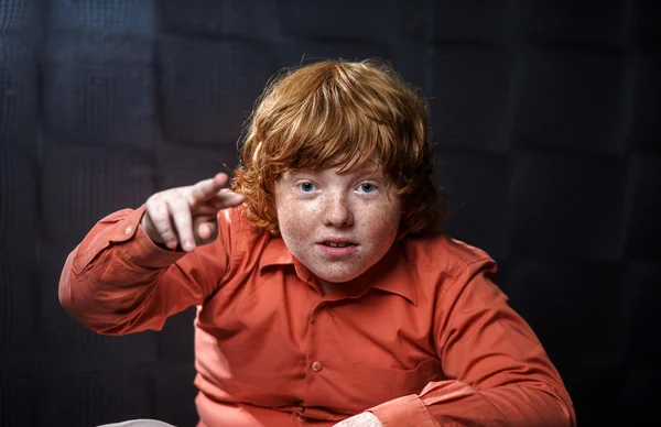 Freckled red-hair boy posing on dark background. — Stock Photo, Image