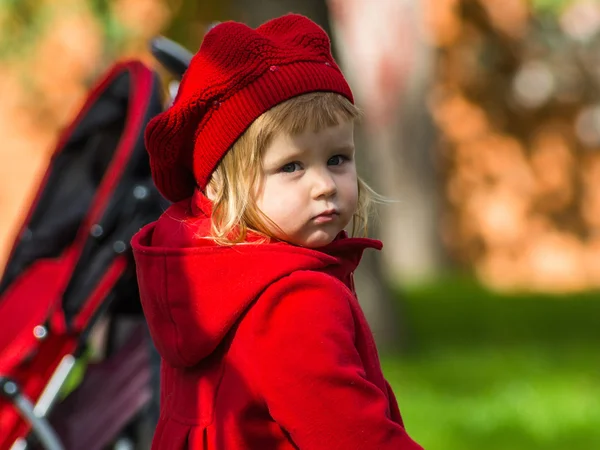 Schattig klein meisje kleden in rode jas — Stockfoto