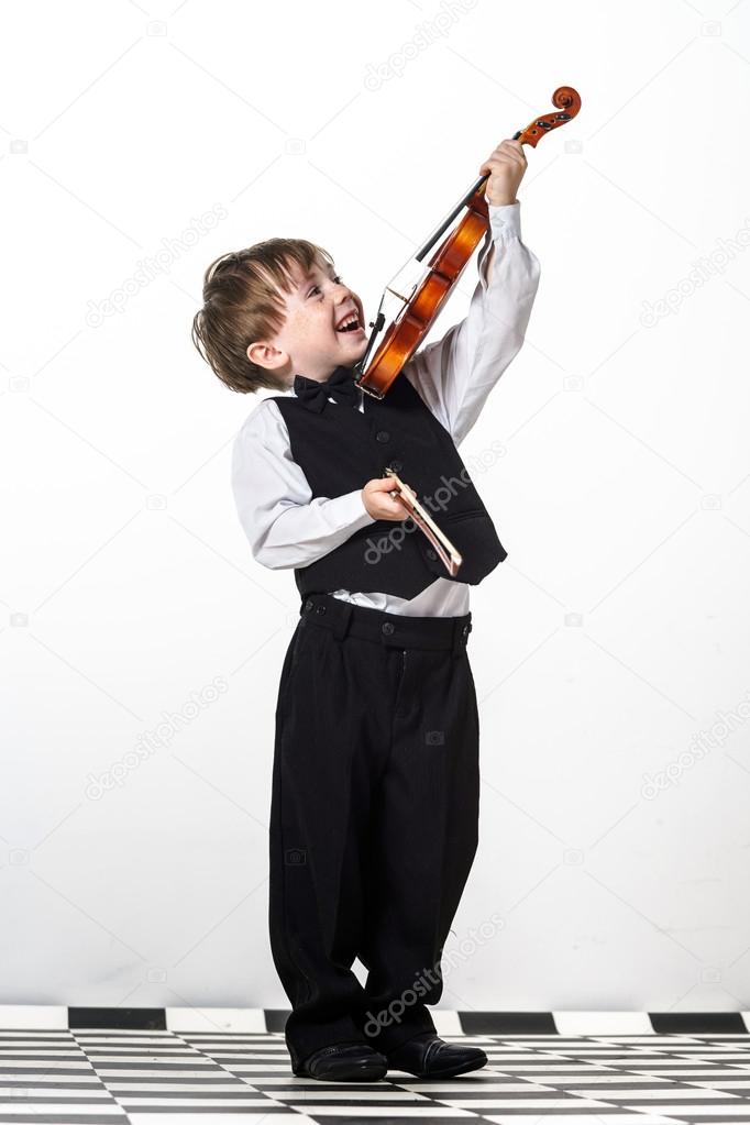 Freckled red-hair boy playing violin.