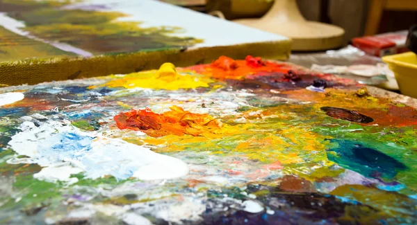 Colorful oils on artist plate — Stock Photo, Image