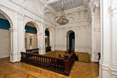 Grand hall in old majestic palace with oak staircase