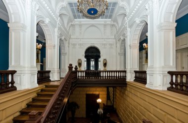 Grand hall in old majestic palace with oak staircase