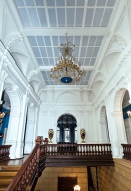 Grand hall in old majestic palace with oak staircase