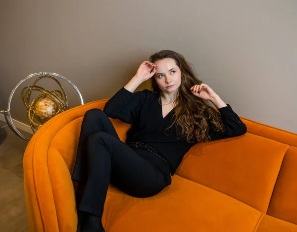 Vacker Ung Flicka Poserar Vacker Ljus Orange Soffa — Stockfoto