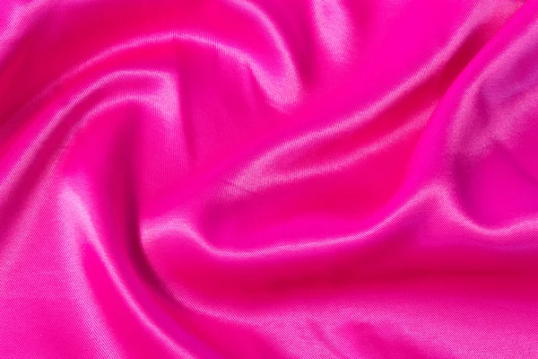 Texture of bright, acid pink fabric with folds — Stock Photo, Image