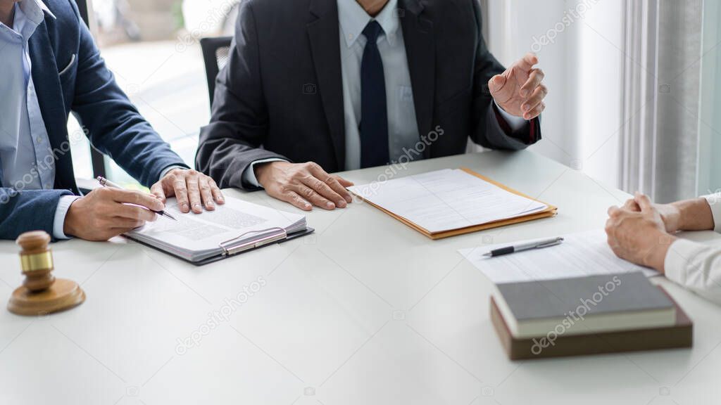 law concept the businessman, a man with the black suit, having a law consultation with the law officer, a man in deep blue suit and his assistant, a man in white shirt.