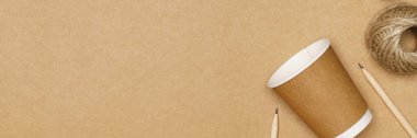 Eco friendly concept, Consist of paper cup and jute rope with pencil on wooden background.