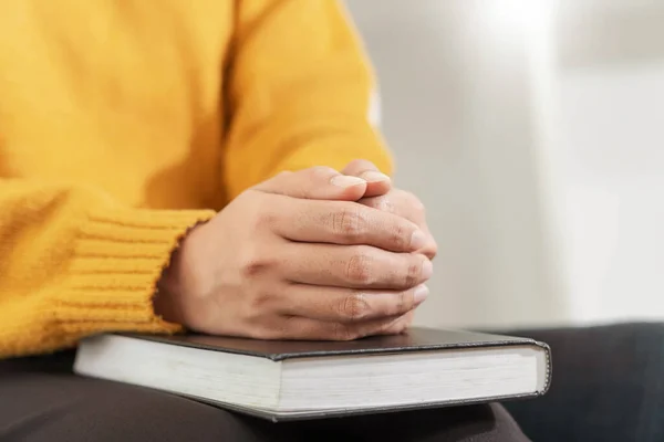 Pray and religion concept, Female christian hands folded on holy bible and praying to god.