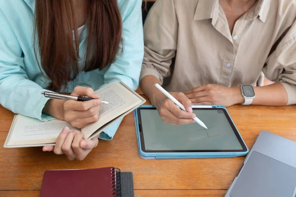 College education concept, Female tutor writing on tablet to tutoring lessons for teenage girl.