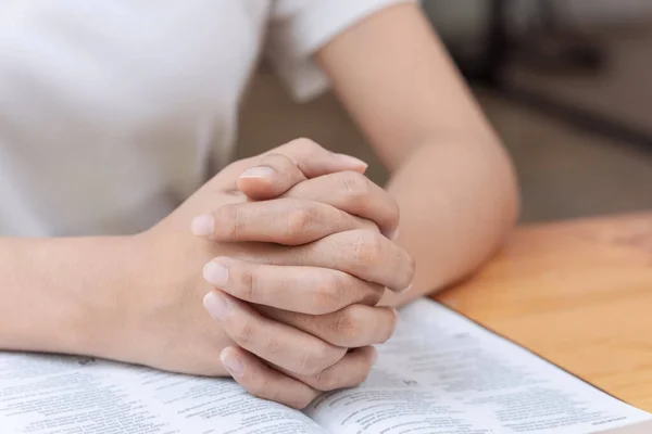 Pray and religion concept, Female christian hands folded and read bible to praying for spirituality