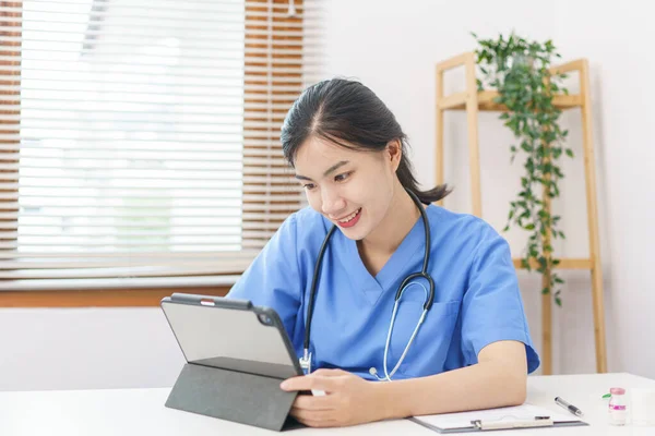 Pet care concept, Female veterinary using tablet for relaxation after examining health pet.