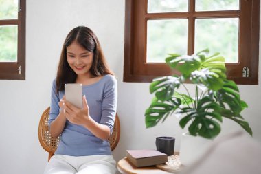 Work from home concept, Business women video call with friend on smartphone after working at home.