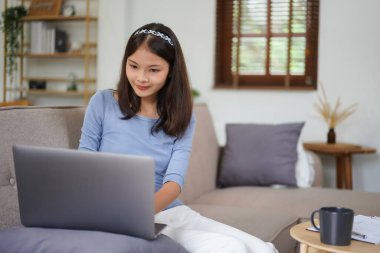 Work from home concept, Business women is typing financial report while working remotely at home.