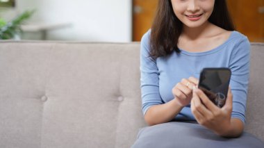Work from home concept, Business women use smartphone to search data while working remotely at home.