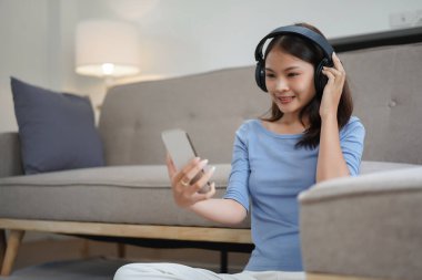 Work from home concept, Business women is relaxation to listening music on smartphone at home.