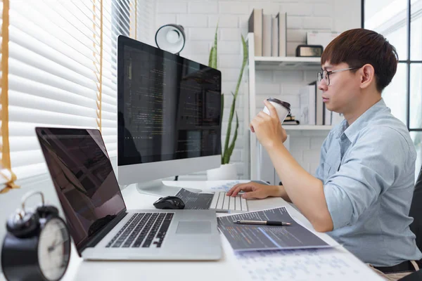 stock image Software development concept, Male programmer checking website programming and drinking coffee.