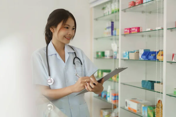 Medicine Health Concept Female Pharmacist Checking Medicine Shelves Checklist Paper — Stock fotografie