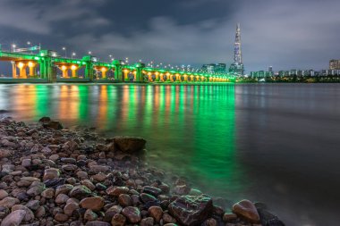 Night view of Jamsil bridge, Lotte World Tower skyscraper and Han River in Seoul South Korea on 5 August 2022