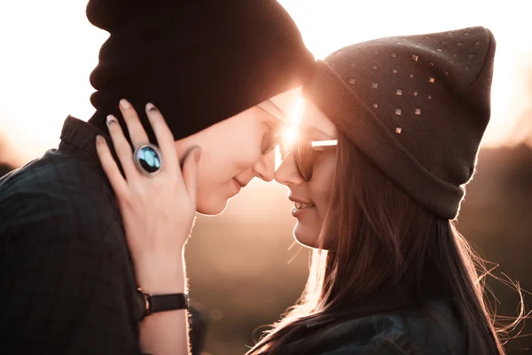 Young fashion hipster couple in love kissing and having passion in spring sunny weather — Stock Photo, Image