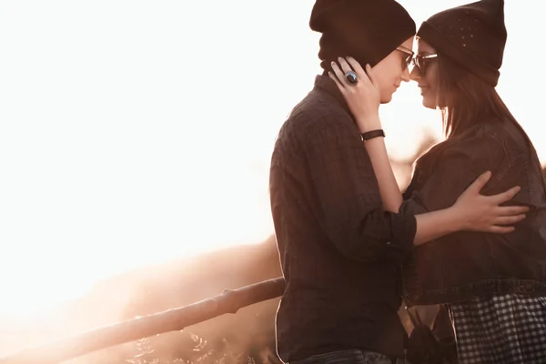 Young fashion hipster couple in love kissing and having passion in spring sunny weather — Stock Photo, Image