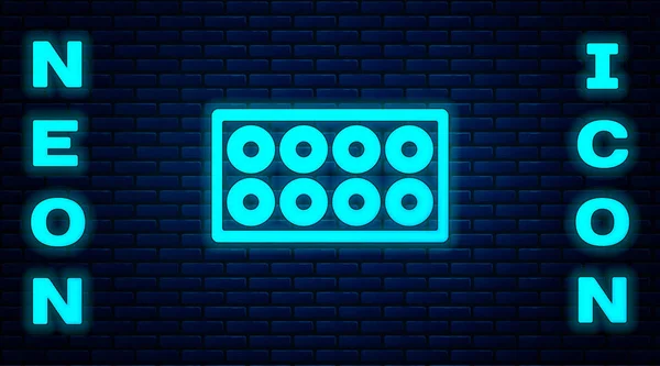 Glowing neon Skateboard wheel icon isolated on brick wall background. Skate wheel. Vector — Stock Vector