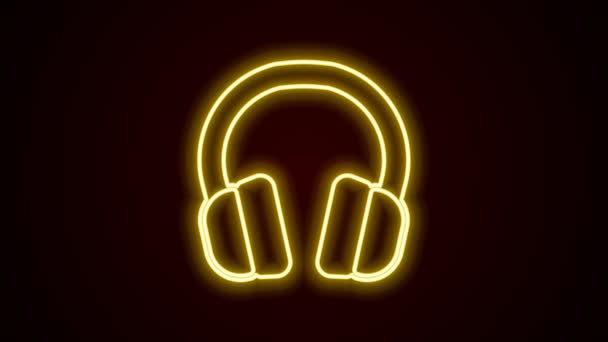Glödande neon line Hörlurar ikonen isolerad på svart bakgrund. Hörlurar. Koncept för att lyssna på musik, service, kommunikation och operatör. 4K Video motion grafisk animation — Stockvideo