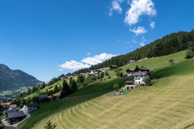 The view of Ortisei town taken from Seceda cable car. Alpine houses along the hills of Val Gardena. Dolomites, Italy