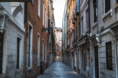 Narrow alleyways in Venice Italy taken early in the morning without a crowd.