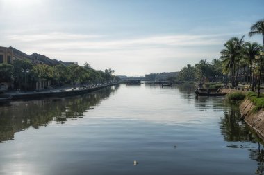 Thu Bon river and An Hoi town reflection taken from Hoi An Ancient town river bank.