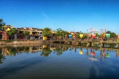 An Hoi bridge and An Hoi town reflection on the Thu Bon River in Hoi An, Vietnam