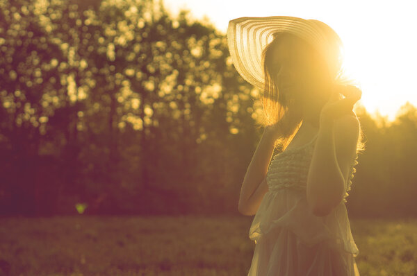 Girl in dress. Sunny field.
