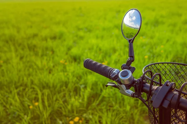 Handlebar with a mirror, which reflects the field and sky with c — Stock Photo, Image