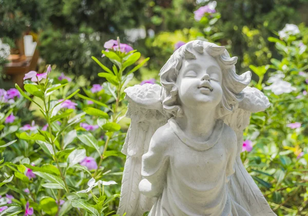 Fairy Statue in the garden with flower — Stock Photo, Image