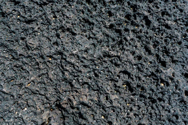 Černý sopečný kámen makro detailní up. — Stock fotografie