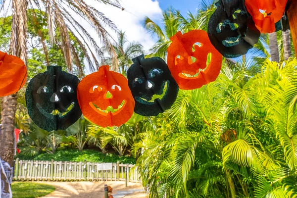 Colore zucche ghirlanda di carta per la festa di Halloween su sfondo foresta tropicale. — Foto Stock