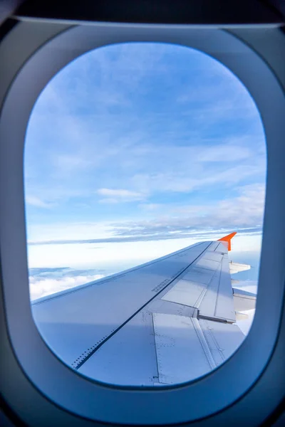 The airplane day sky, view above snow mountains from cabin window. — Stock fotografie