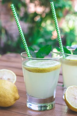 glasses of lemonade with mint and ice - closeup