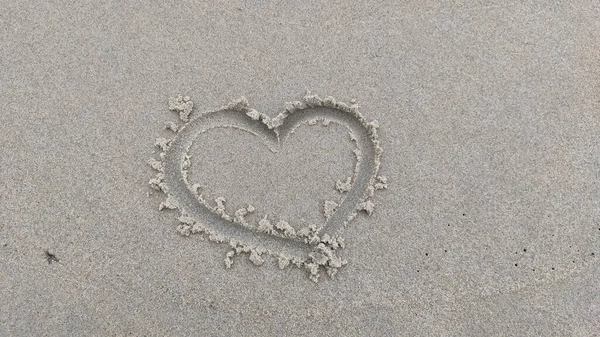 Coeur dessiné sur le sable sur le rivage, symbole d'amour — Photo