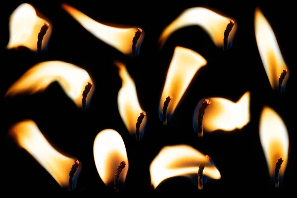 A set of candle flames on a black background, a collection of twelve images for your photos. Collection of fire — Stock Photo, Image