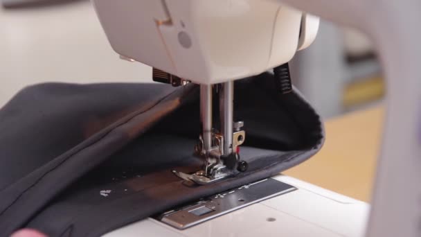 Sewing process. Close-up of repairing clothes, sewing on a sewing machine. Clothing repair concept. Consumption reduction concept. Caring for the environment. — Stock Video