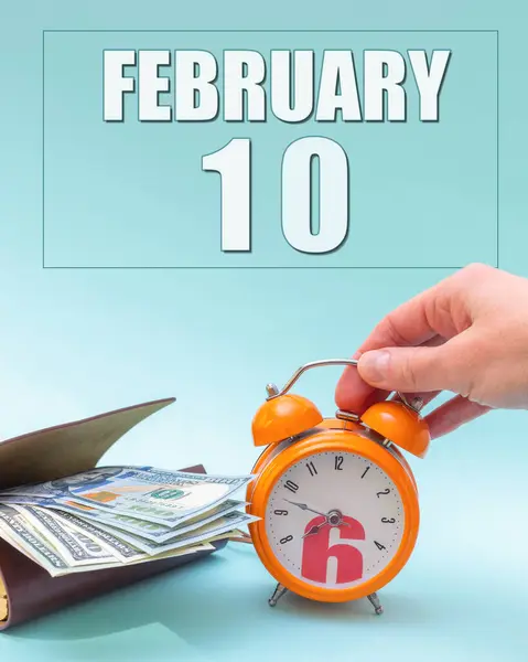 February 10Th Hand Holding Orange Alarm Clock Wallet Cash Calendar — Stock Photo, Image