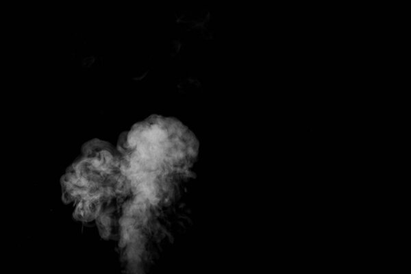 Swirling, wriggling smoke, heart-shaped steam, isolated on a black background for overlaying on your photos. Romantic couple. Love fragrance. Abstract smoky background, design element
