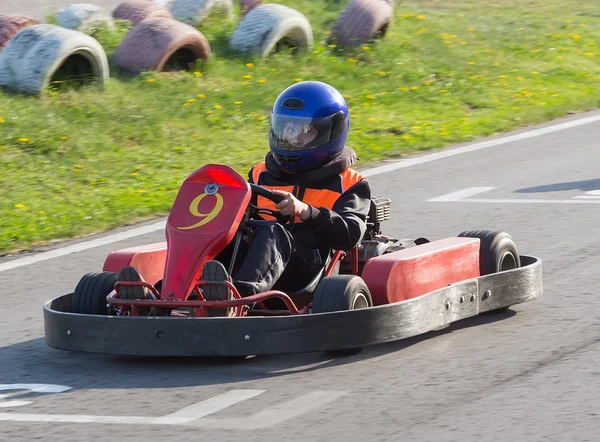 The child moves directly on a go-cart to carting club